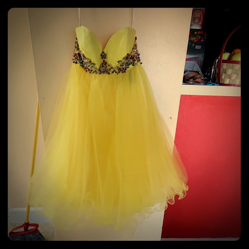 A beautiful yellow prom dress with colorful stones